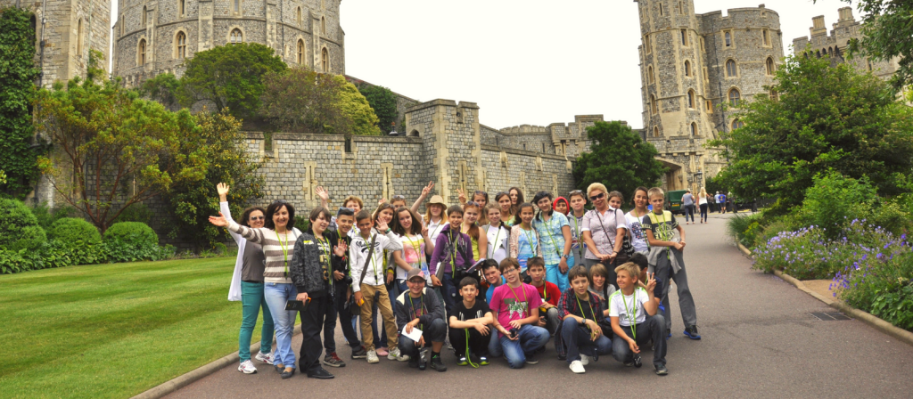 A happy group of Russian students during an excursion to an English castle